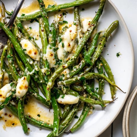 Imagine hot, cheesy Cheesy Garlic Roasted Green Beans, browned roasting notes; sprinkle with parsley.