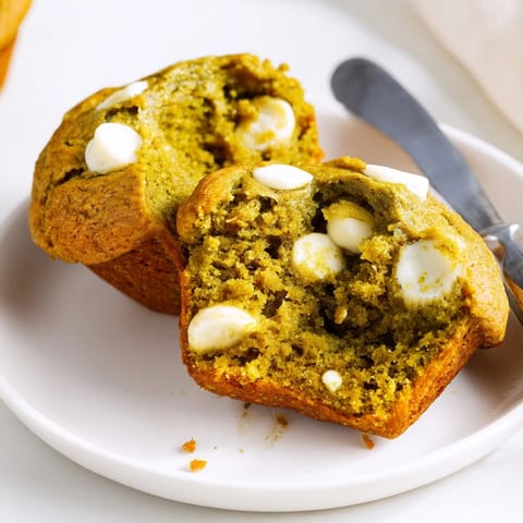 Close-up reveals moist Matcha White Chocolate Pumpkin Muffin crumb with melted white chocolate chips.