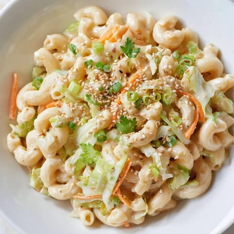 Vibrant Mac and Cheese Egg Roll Stir-Fry served steaming hot with fresh herbs.  