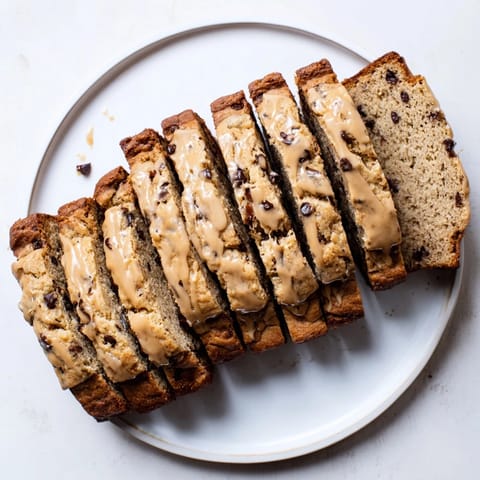Slice of rich coffee cream banana bread with melted chocolate chips and bananas.  
