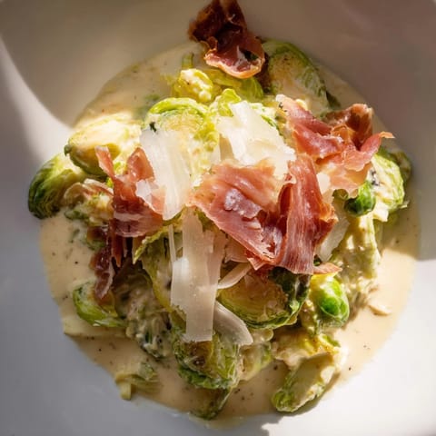 Golden-brown sautéed Brussels sprouts in a flavorful Warm Brussels Sprouts Caesar, a delicious meal.