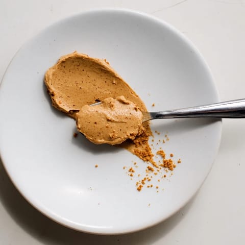 Golden, shimmering Quick Christmas Cookie Butter Spread, enticingly smooth and perfect for dipping apples.