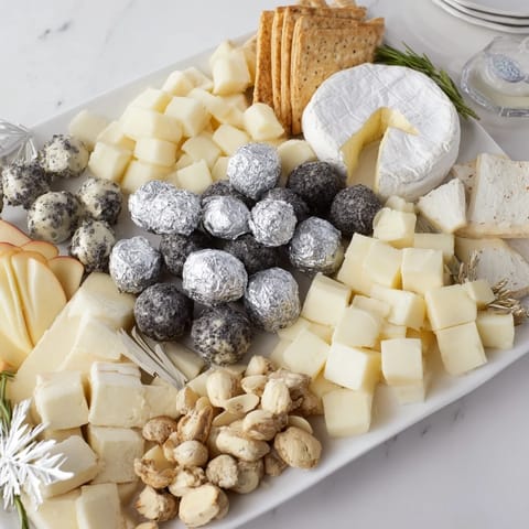Elegant The Silver Screen cheese board, featuring truffle brie, chocolates, and grapes, perfect for movie night.