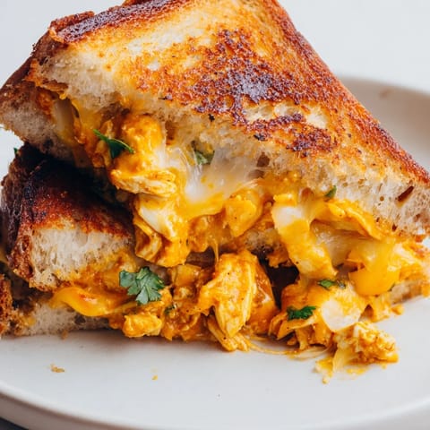 Warm, spicy butter chicken nestled between cheese and bread in this grilled cheese recipe.