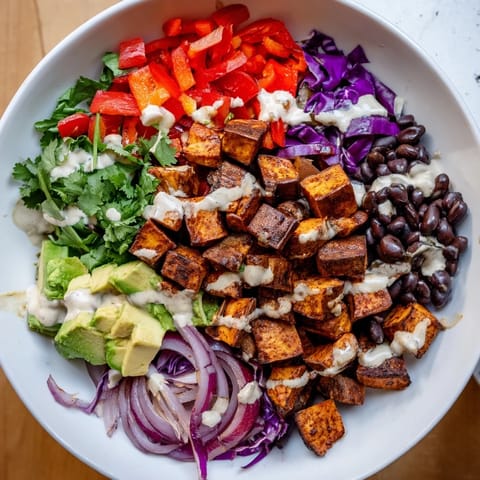 A close-up of delicious sweet potato taco bowls, featuring fresh avocado and cilantro garnishes.