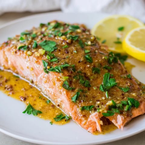 Vibrant oven-baked Honey Mustard Salmon with a sweet and tangy glaze, perfect for a quick dinner.