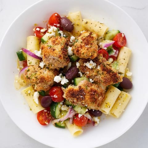 Tender pasta and crispy chicken combine in this vibrant, delicious Crispy Chicken Greek Pasta.