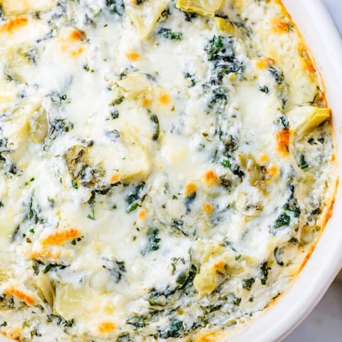 Fresh spinach and tender artichoke hearts baked with melted mozzarella and Parmesan in a savory appetizer.  