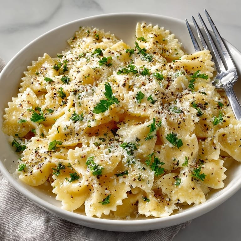 Buttery Creamy Garlic Parmesan Farfalle recipe: enjoy a comforting, cheesy pasta dinner tonight.