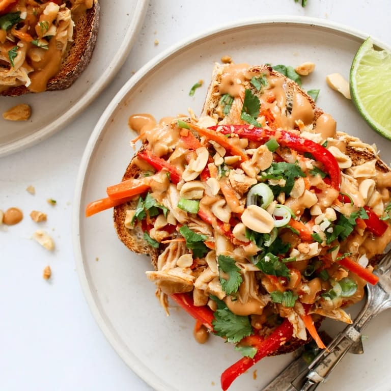 Savory Thai Peanut Pinto Chicken Toast garnished with cilantro and crunchy peanuts.