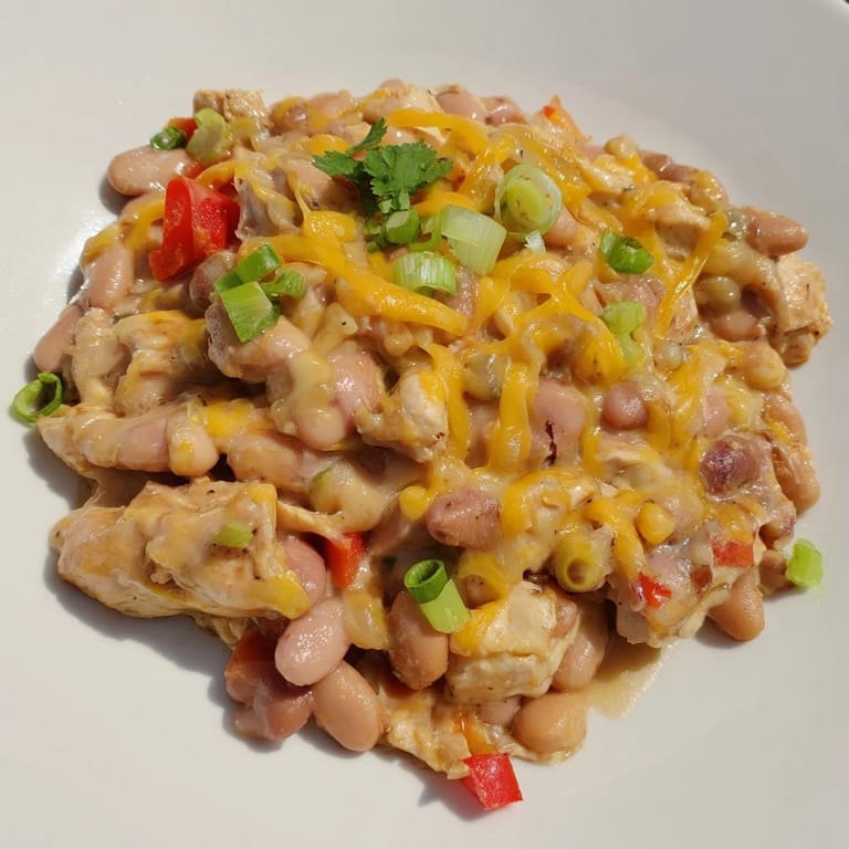 Spicy Cajun Chicken Cheddar Pintos simmered with creamy beans and vibrant vegetables.  