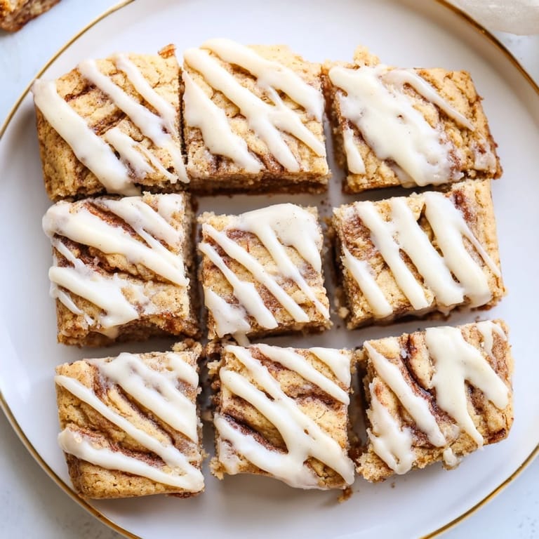 Warm, gooey Cinnamon Roll Cookie Bars ready to satisfy your sweet tooth cravings.