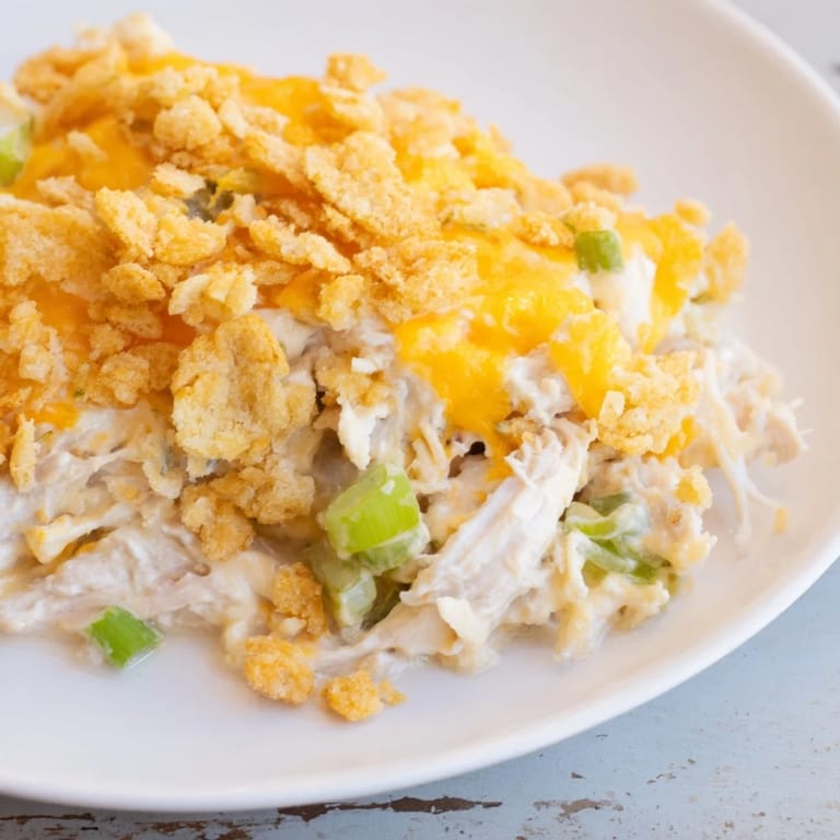 Warm and comforting Neiman Marcus-Style Chicken Casserole with visible shredded chicken, cheese, and a perfect crust.