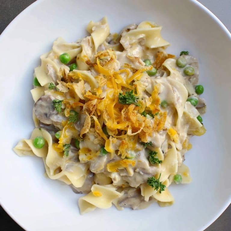 Delicious, warm Tuna Noodle Casserole with visible textures and a savory, bubbling cheese sauce.