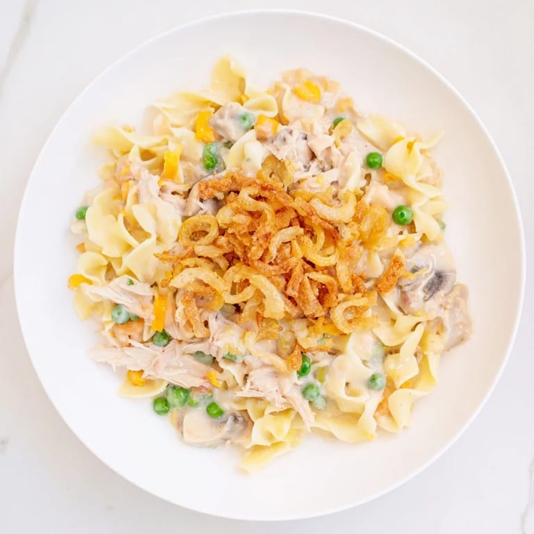A close-up of a bubbling creamy tuna noodle casserole just out of the oven, ready to serve.