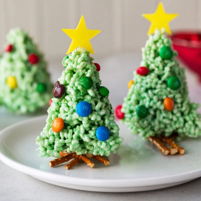 Deliciously shaped Christmas Tree Rice Crispy Treats, a sweet treat ready for decorating with sprinkles and star candies.