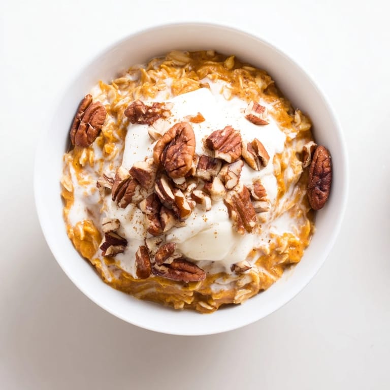 Warm, comforting Pumpkin Spice Latte Oats, topped with crunchy pecans ready to enjoy for breakfast.