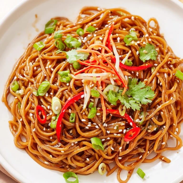 Delicious Asian Garlic Noodle Bowl served hot, with visible noodles and hints of chili adding color.