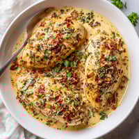 A plate of chicken with sauce on it.