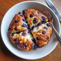 A slice of fluffy cottage cheese blueberry cloud bread.