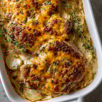 A dish of food with a cheese sauce.