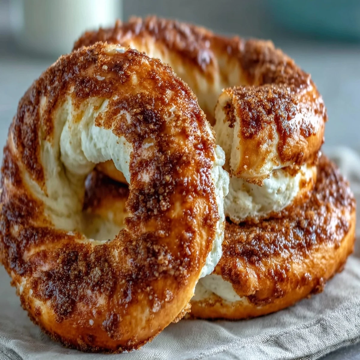 Fluffy yogurt bagels with cinnamon swirl, golden and soft, topped with a sweet cinnamon sugar crust.