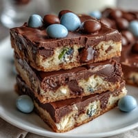 Soft, chewy Cadbury Egg Cookie Bars loaded with pastel M&Ms and crunchy mini egg pieces, perfect for spring celebrations.