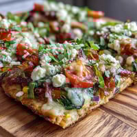 Vibrant St. Patricks Day Rainbow Veggie Flatbread Pizza with colorful fresh vegetables arranged in festive rainbow stripes over melted cheese.